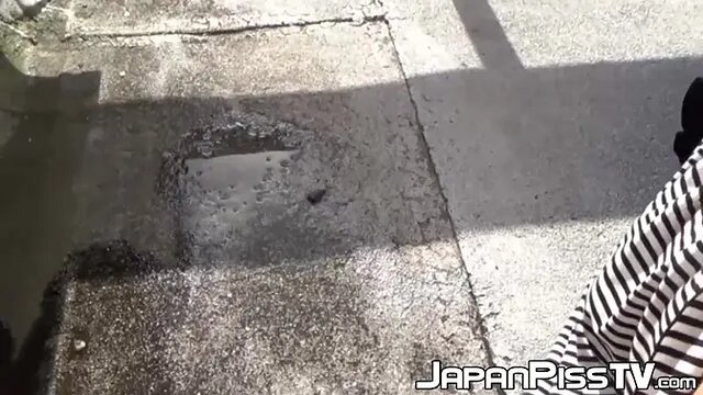 Hairy redhead Asian chick plays with her pussy and pees outside